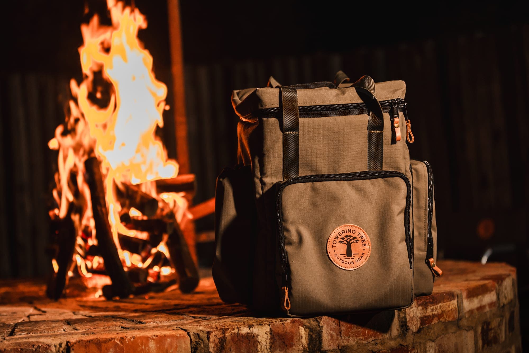 Towering Tree Adventure Cooler Backpack by the campfire